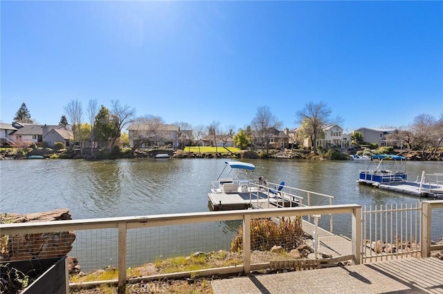 dock area featuring a water view and a residential view