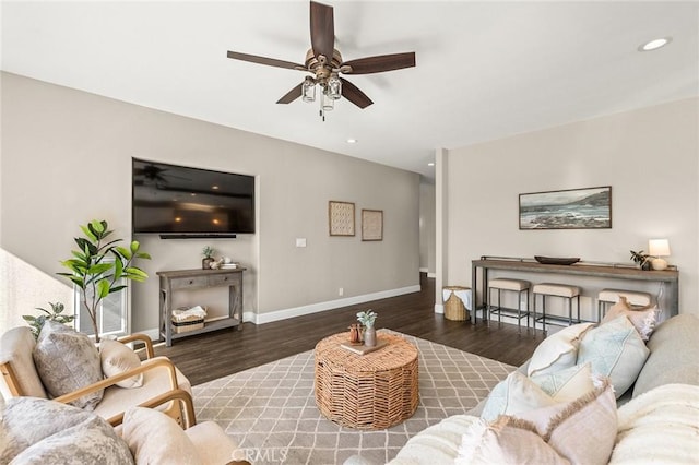 living area with a ceiling fan, baseboards, wood finished floors, and recessed lighting