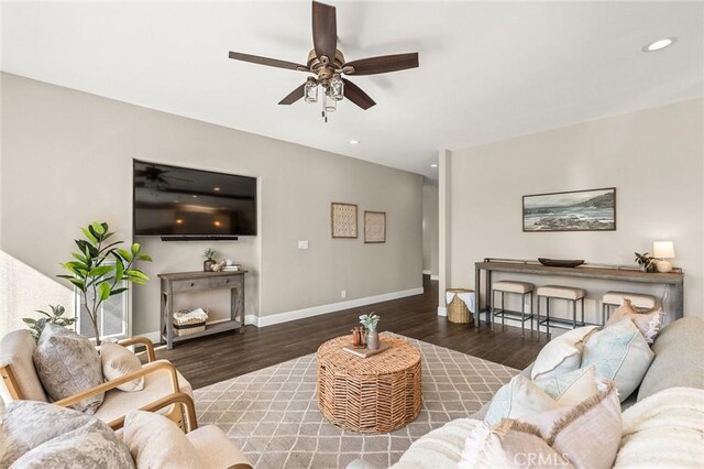 living room featuring ceiling fan, baseboards, wood finished floors, and recessed lighting