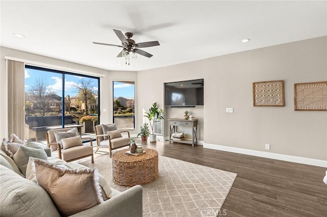 living area with recessed lighting, wood finished floors, a ceiling fan, and baseboards