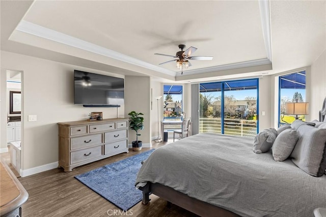 bedroom featuring access to outside, a raised ceiling, and crown molding