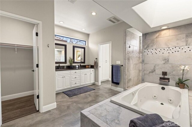 bathroom with baseboards, a whirlpool tub, visible vents, and recessed lighting