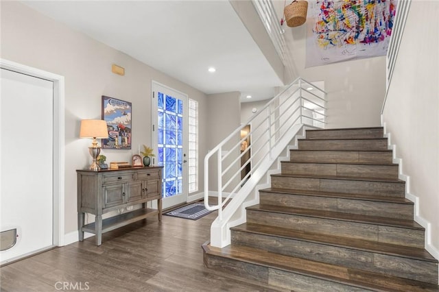 stairway featuring recessed lighting, baseboards, and wood finished floors