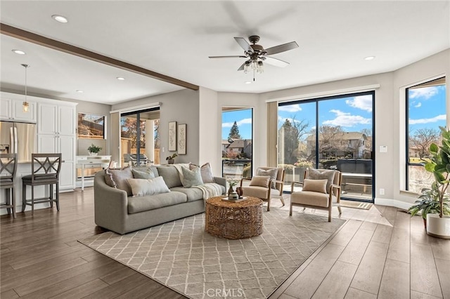 living room featuring ceiling fan, baseboards, wood finished floors, and recessed lighting