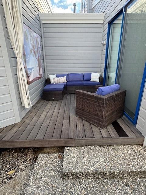 wooden terrace featuring an outdoor living space