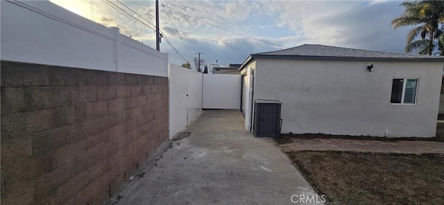 view of property exterior featuring fence and stucco siding