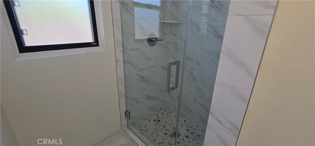 bathroom with a marble finish shower