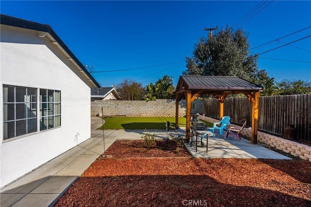 view of yard featuring a patio area, a fenced backyard, and a gazebo