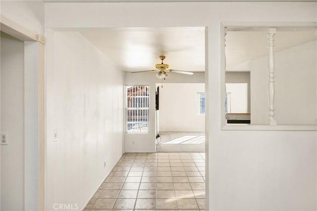 unfurnished room featuring a ceiling fan and light tile patterned flooring