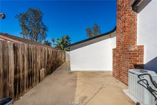 view of patio / terrace featuring central AC unit and fence