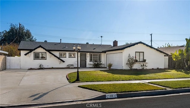 ranch-style home featuring a garage, driveway, a front yard, and stucco siding