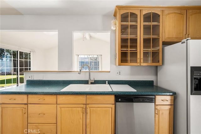 kitchen with white refrigerator with ice dispenser, a sink, dishwasher, dark countertops, and glass insert cabinets