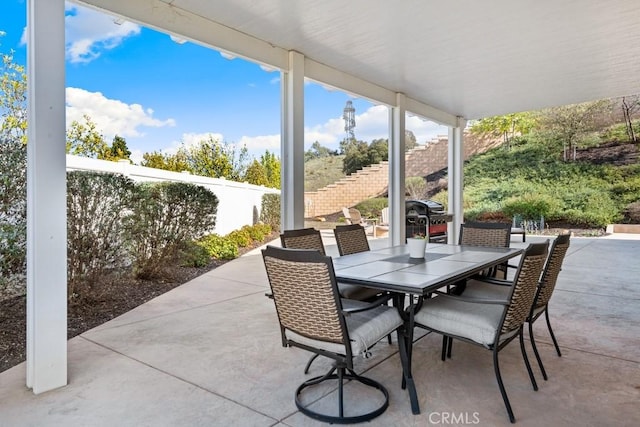 view of patio / terrace with outdoor dining space and fence