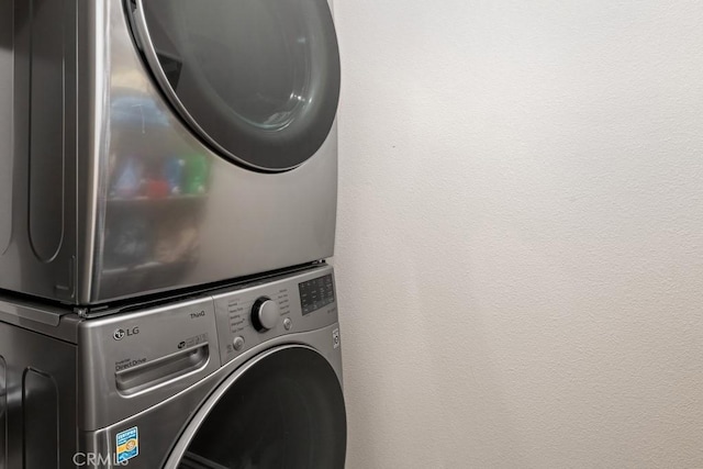 laundry area with stacked washer and clothes dryer and laundry area