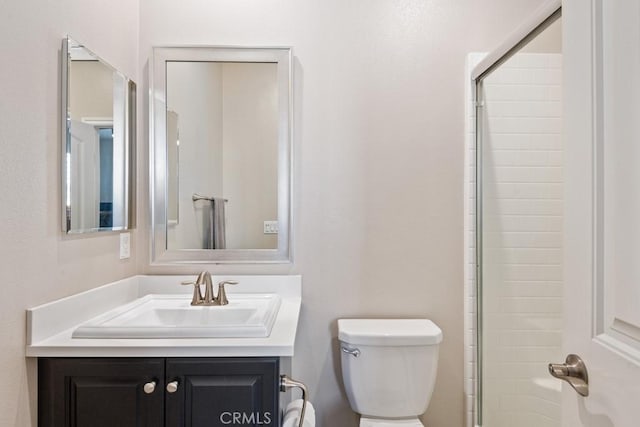 bathroom featuring walk in shower, vanity, and toilet