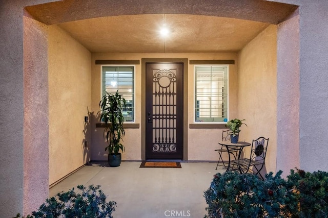 property entrance with stucco siding