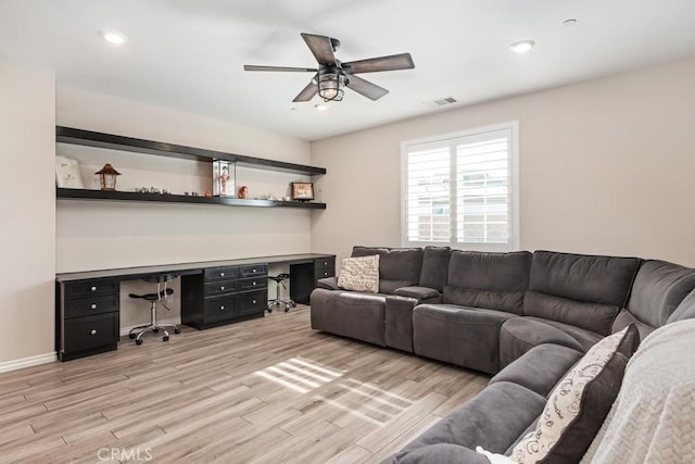 living room with built in desk, light wood finished floors, recessed lighting, visible vents, and a ceiling fan