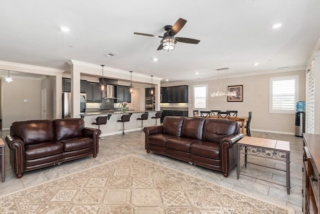 living area featuring a healthy amount of sunlight, ceiling fan, visible vents, and crown molding