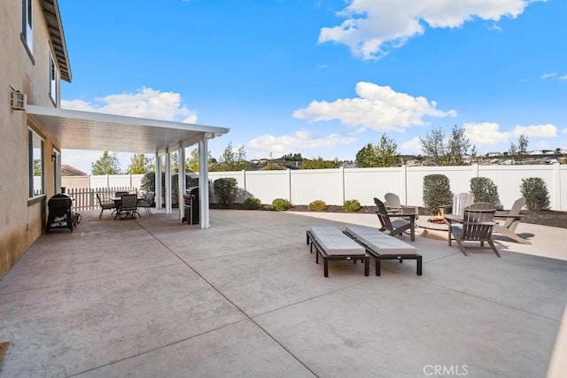 view of patio / terrace with an outdoor fire pit and a fenced backyard