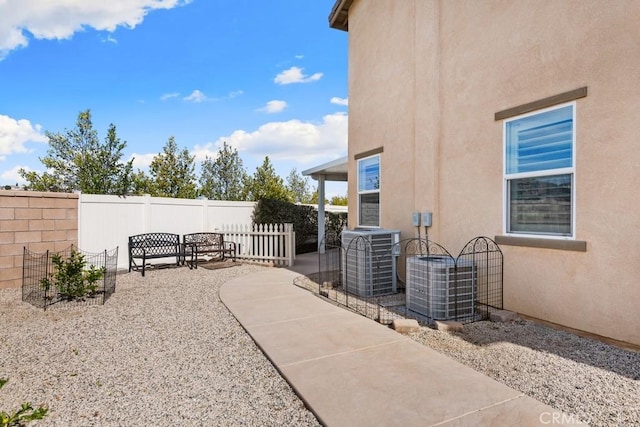 view of patio with fence and central AC