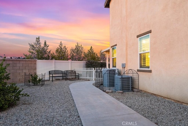 view of yard with a patio area, fence, and central air condition unit