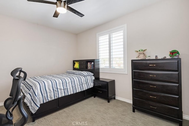 carpeted bedroom featuring ceiling fan and baseboards