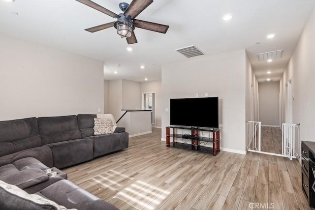 living room with baseboards, recessed lighting, visible vents, and light wood-style floors