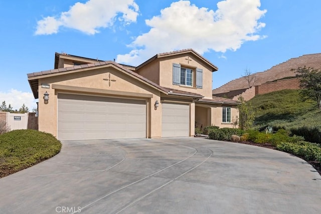 view of front of home with driveway, an attached garage, and stucco siding