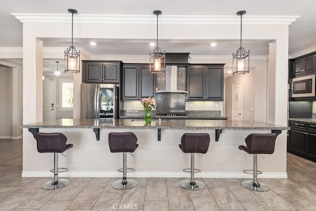 kitchen featuring a breakfast bar, appliances with stainless steel finishes, backsplash, dark stone counters, and wall chimney exhaust hood