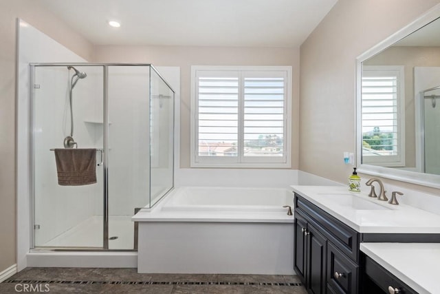 full bath featuring recessed lighting, a shower stall, vanity, and a bath