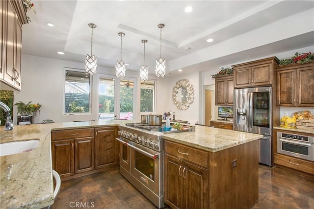 kitchen with a tray ceiling, stainless steel appliances, recessed lighting, a sink, and light stone countertops