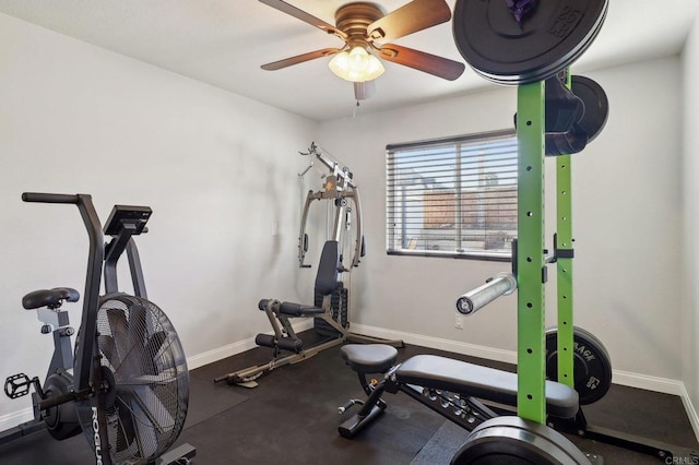 workout area with ceiling fan and baseboards