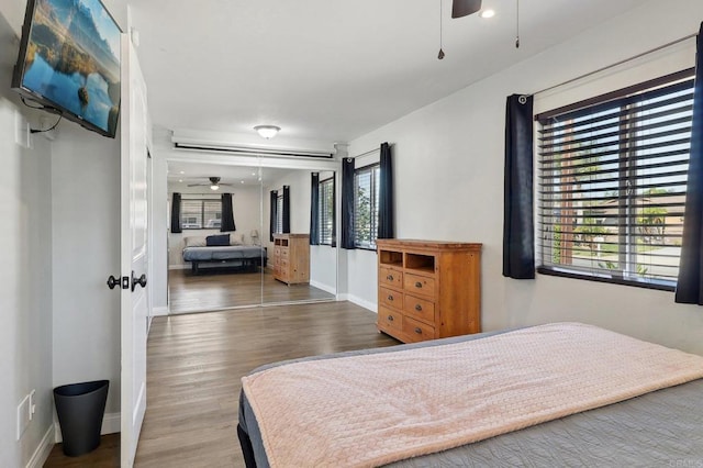 bedroom with wood finished floors and baseboards