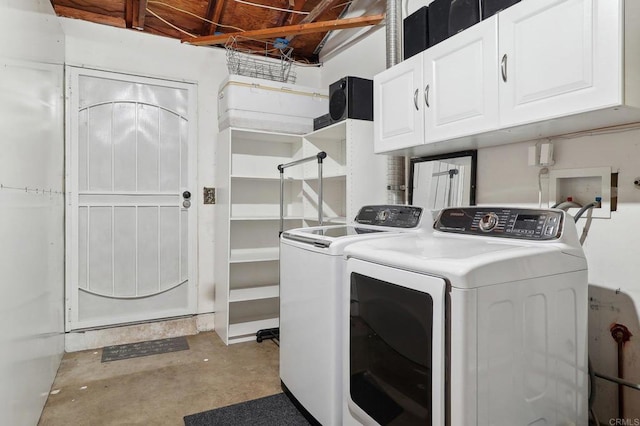 washroom featuring cabinet space and independent washer and dryer