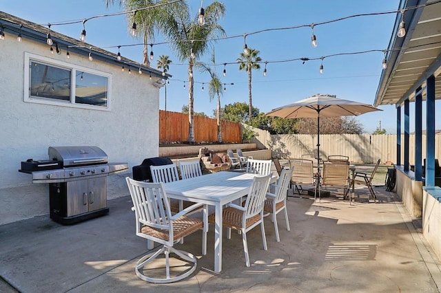 view of patio with a fenced backyard, outdoor dining area, and area for grilling