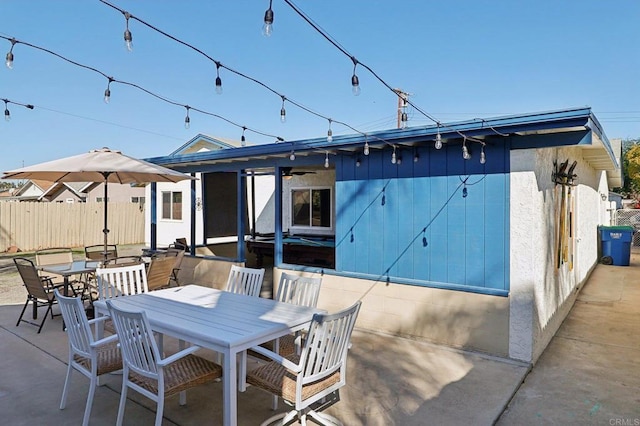 back of house featuring a patio area, ceiling fan, fence, and outdoor dining area