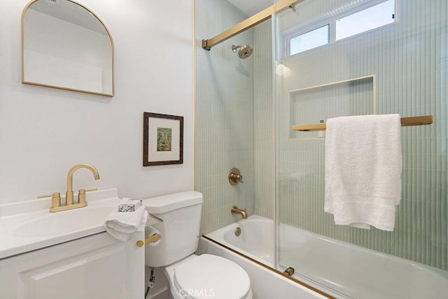 bathroom featuring vanity, toilet, and bath / shower combo with glass door