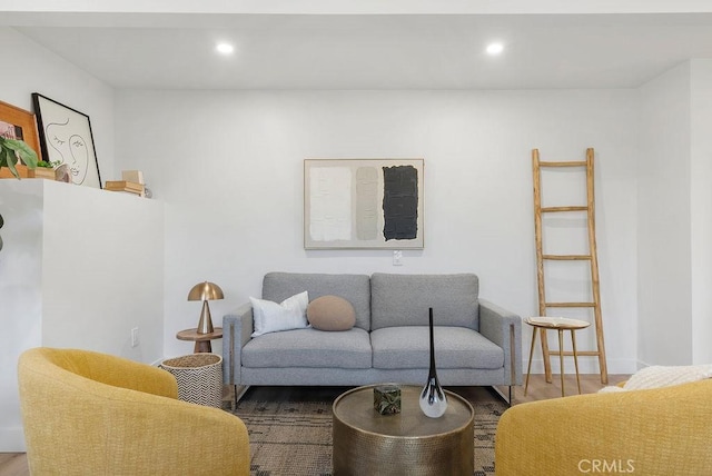 living area featuring recessed lighting, baseboards, and wood finished floors