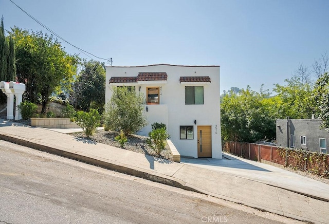 view of front of home with fence and stucco siding