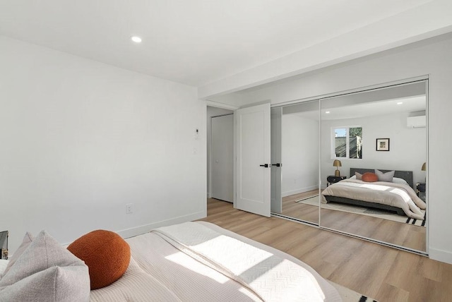 bedroom with recessed lighting, a closet, baseboards, and light wood finished floors