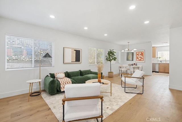 living room featuring recessed lighting, light wood-style flooring, and baseboards