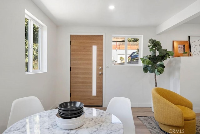 dining area featuring baseboards and wood finished floors