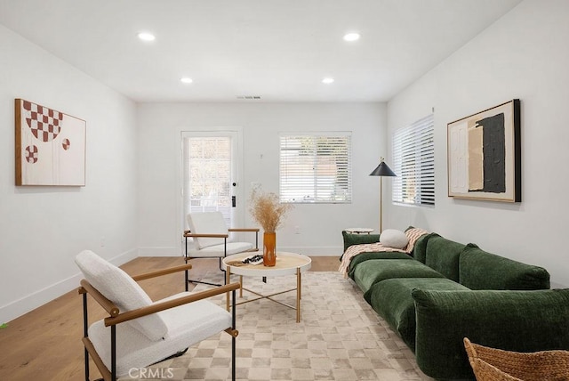 living room with recessed lighting, visible vents, light wood finished floors, and baseboards