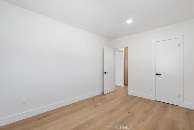 unfurnished bedroom with recessed lighting, baseboards, and light wood finished floors