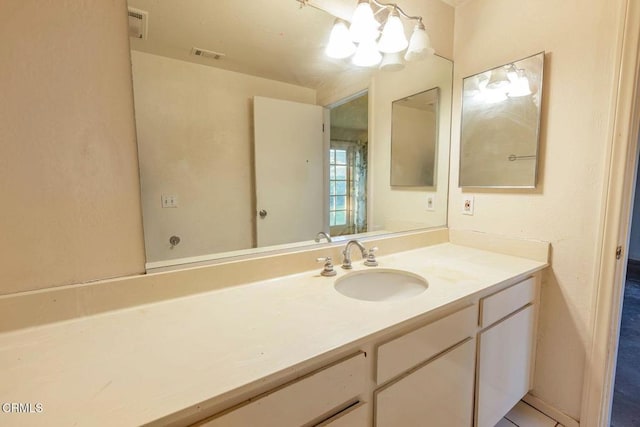 bathroom featuring visible vents and vanity