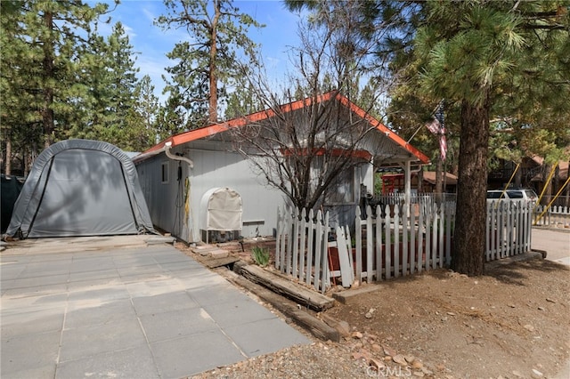 view of property exterior featuring fence