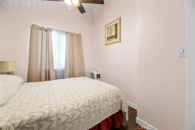 bedroom with a ceiling fan, vaulted ceiling, and baseboards