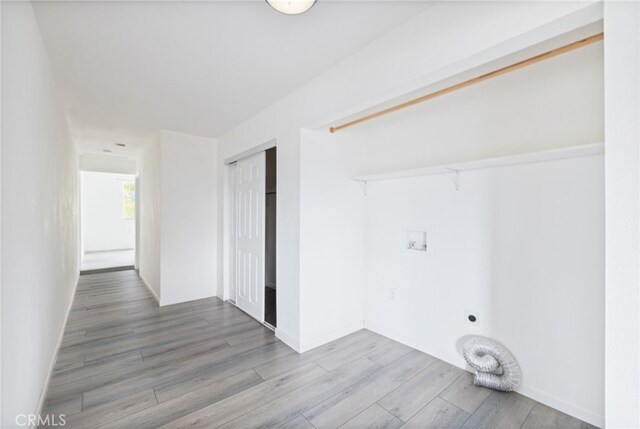 clothes washing area with washer hookup, hookup for an electric dryer, wood finished floors, and laundry area
