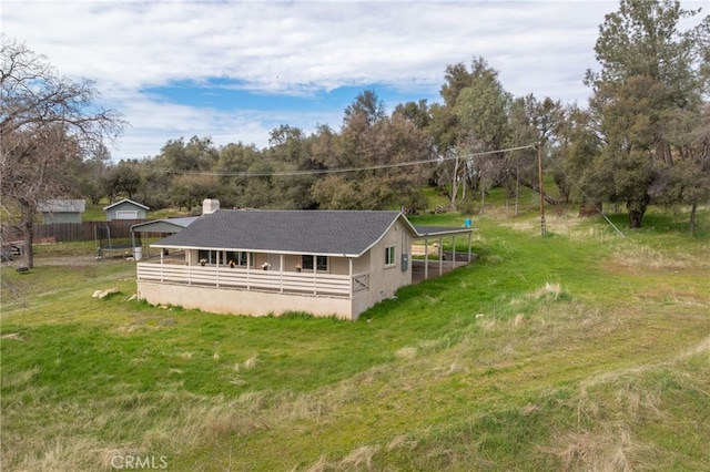 rear view of property with a yard