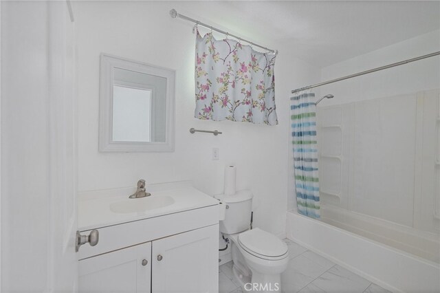 bathroom featuring shower / tub combo with curtain, vanity, marble finish floor, and toilet